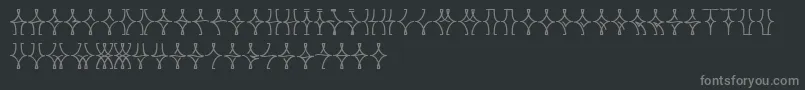 フォントNellyfrdNormal – 黒い背景に灰色の文字