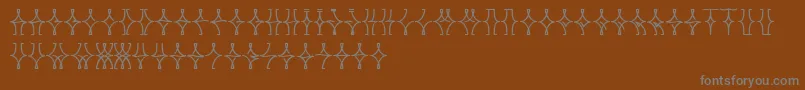 フォントNellyfrdNormal – 茶色の背景に灰色の文字