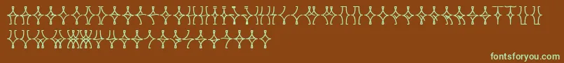 フォントNellyfrdNormal – 緑色の文字が茶色の背景にあります。