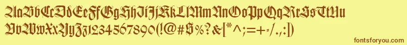 フォントHapsburg – 茶色の文字が黄色の背景にあります。