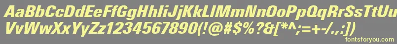 UniversNextProExtrablackCondensedItalic-Schriftart – Gelbe Schriften auf grauem Hintergrund