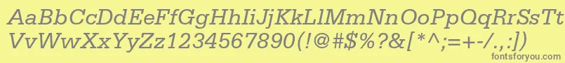 SerifastdItalic-fontti – harmaat kirjasimet keltaisella taustalla