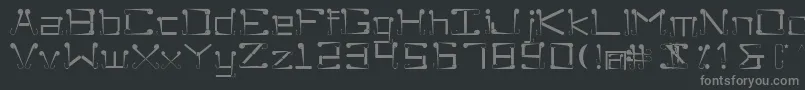 Sukolilo-fontti – harmaat kirjasimet mustalla taustalla