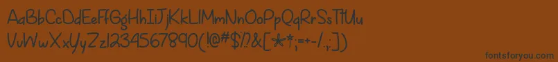 フォントSpringIsComingOtf – 黒い文字が茶色の背景にあります