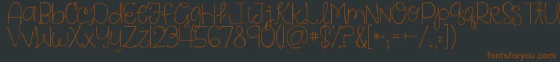Kgsaysomething-Schriftart – Braune Schriften auf schwarzem Hintergrund