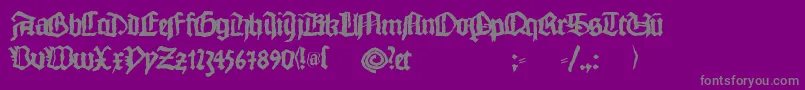 Monkswriting-fontti – harmaat kirjasimet violetilla taustalla