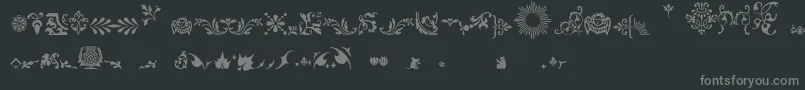 フォントFleurons – 黒い背景に灰色の文字