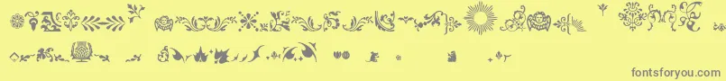 フォントFleurons – 黄色の背景に灰色の文字