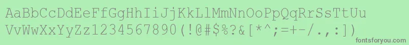 CourierNewCyr85n-fontti – harmaat kirjasimet vihreällä taustalla
