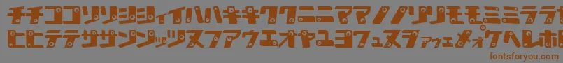 フォントKankanaK – 茶色の文字が灰色の背景にあります。