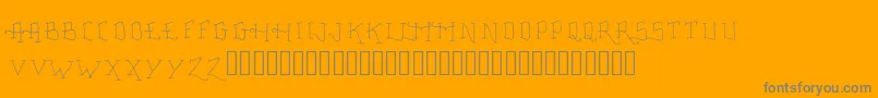 FancyTattooScript-fontti – harmaat kirjasimet oranssilla taustalla