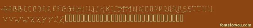 フォントFancyTattooScript – 緑色の文字が茶色の背景にあります。