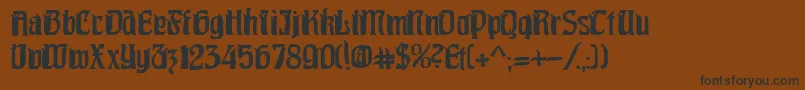 フォントPittoresk – 黒い文字が茶色の背景にあります