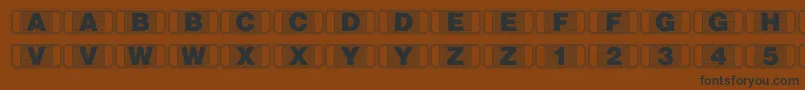 Stagtickets-Schriftart – Schwarze Schriften auf braunem Hintergrund