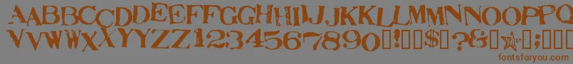 フォントStampActJumbled – 茶色の文字が灰色の背景にあります。