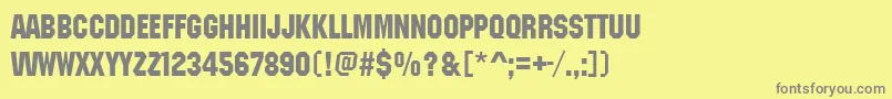 フォントMachineitcdee – 黄色の背景に灰色の文字