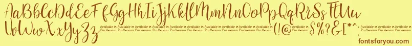 フォントSaniesScript – 茶色の文字が黄色の背景にあります。
