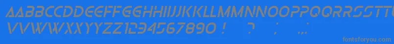 OlgaItalic-fontti – harmaat kirjasimet sinisellä taustalla
