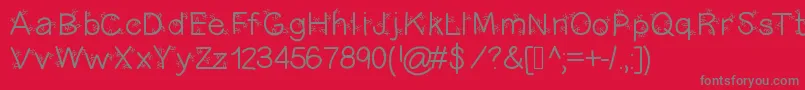 フォントChristmasligtness – 赤い背景に灰色の文字