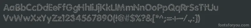 Irritate-Schriftart – Graue Schriften auf schwarzem Hintergrund