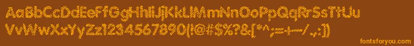 フォントIrritate – オレンジ色の文字が茶色の背景にあります。