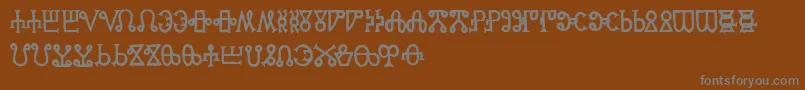 GlagoliticAoe-fontti – harmaat kirjasimet ruskealla taustalla