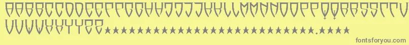 フォントReubalach – 黄色の背景に灰色の文字