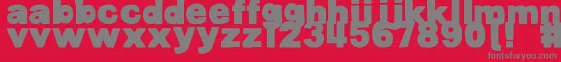 Fonte DjbBellyButtonInnie – fontes cinzas em um fundo vermelho