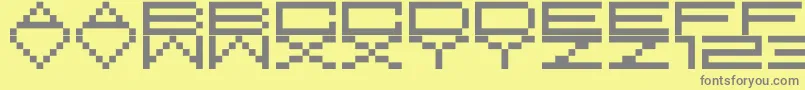 M37FeelTheBit-fontti – harmaat kirjasimet keltaisella taustalla