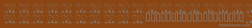 フォントJlrQuincy – 茶色の背景に灰色の文字