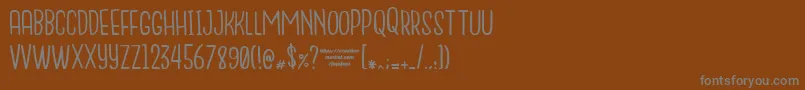 フォントNanda – 茶色の背景に灰色の文字