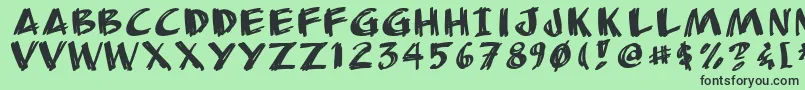 フォントAnudrg – 緑の背景に黒い文字