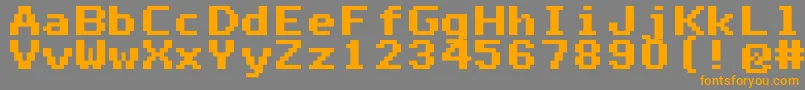 フォントMono0765 – オレンジの文字は灰色の背景にあります。