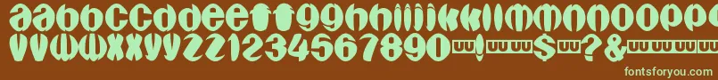 フォントAragones – 緑色の文字が茶色の背景にあります。