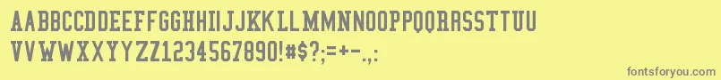 CollegeCondensed-fontti – harmaat kirjasimet keltaisella taustalla