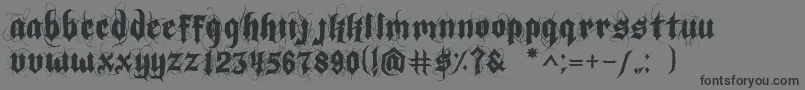 IndoctrineJlloyd-Schriftart – Schwarze Schriften auf grauem Hintergrund