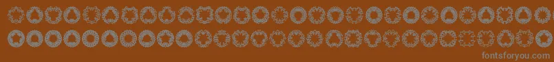 Ovul2ov-Schriftart – Graue Schriften auf braunem Hintergrund