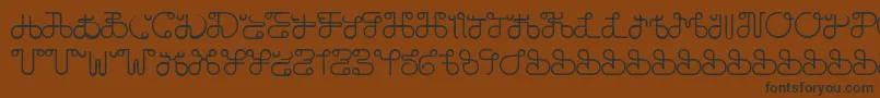 フォントDobilasSteady – 黒い文字が茶色の背景にあります