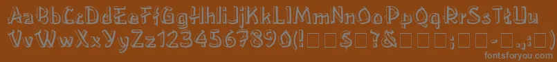 LowereastsideMedium-fontti – harmaat kirjasimet ruskealla taustalla