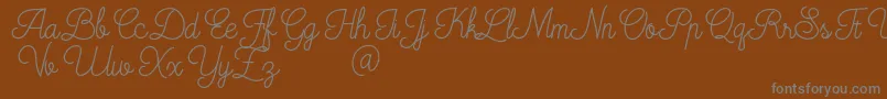 Mooglonk-fontti – harmaat kirjasimet ruskealla taustalla