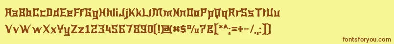 フォントWewak – 茶色の文字が黄色の背景にあります。