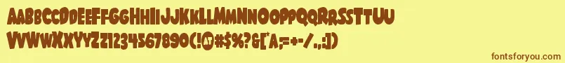 フォントShablagoocond – 茶色の文字が黄色の背景にあります。