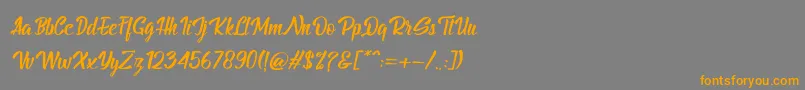 フォントBillyTheGangItalic – オレンジの文字は灰色の背景にあります。