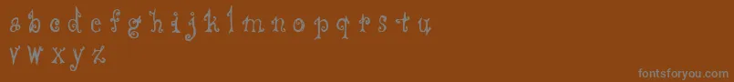 Cffredostyle-fontti – harmaat kirjasimet ruskealla taustalla