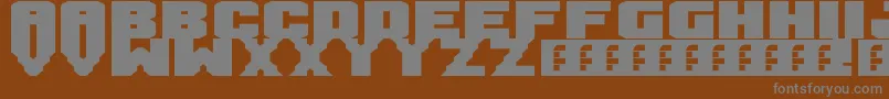 Mandarin-fontti – harmaat kirjasimet ruskealla taustalla