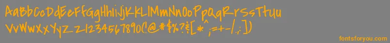 フォントCovered – オレンジの文字は灰色の背景にあります。