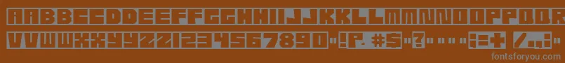 Etcher04-Schriftart – Graue Schriften auf braunem Hintergrund