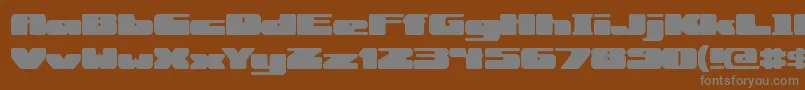 RotundBrk-fontti – harmaat kirjasimet ruskealla taustalla