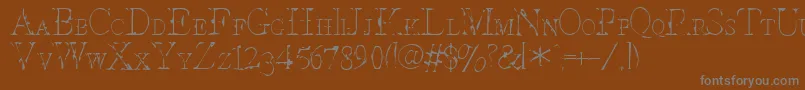 Intesc-fontti – harmaat kirjasimet ruskealla taustalla
