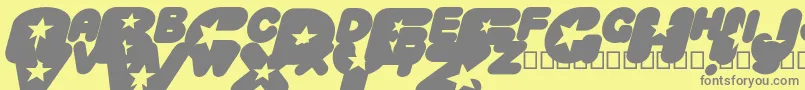 CrystaluniverseOblique-fontti – harmaat kirjasimet keltaisella taustalla